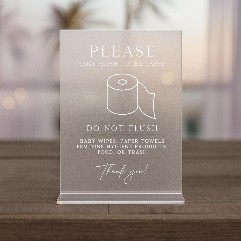 May include: A clear acrylic sign with the text "PLEASE ONLY FLUSH TOILET PAPER" and "DO NOT FLUSH" with a toilet paper roll graphic. The sign also includes a list of items not to flush and the words "Thank you!"