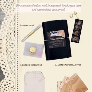 May include: A Novaira Journal set including a black leather journal cover, an extra cord, a bag of random charms, a journal pouch, and three blank notebook inserts. The set features a thank you card, a cat-themed bookmark, and a gold key charm.