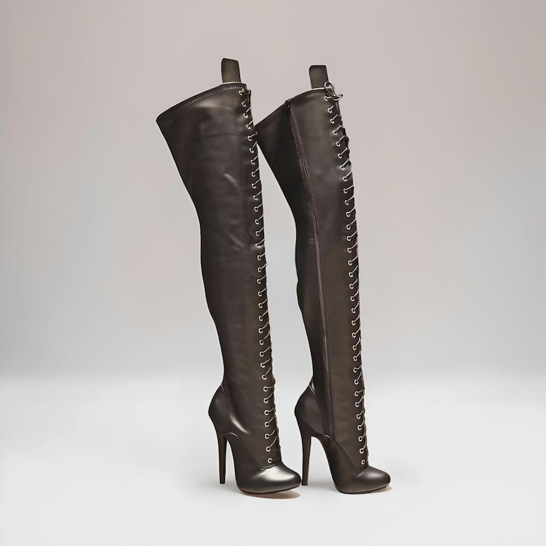 “High heel lace-up knee boots with 14cm stiletto heel and round toe design on clean studio background.”
