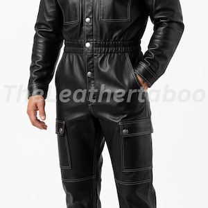 May include: Black leather jumpsuit with white stitching, featuring a collared neckline, button-up front, and multiple pockets. The jumpsuit has a cinched waist and is worn with black boots. The text "Theleathertaboo" is visible.