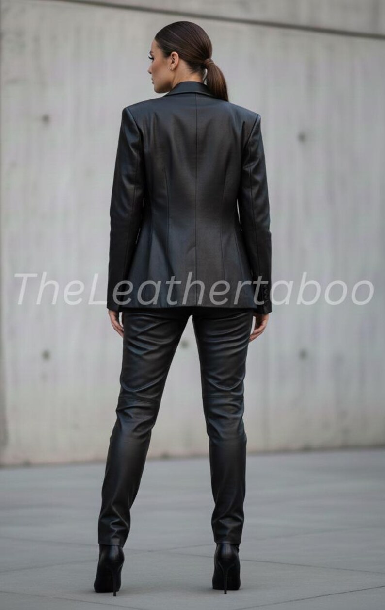 May include: A black leather suit, including a blazer and pants, is shown from the back. The blazer has structured shoulders and a tailored fit. The pants are form-fitting. The text "Theleathertaboo" is visible on the image.