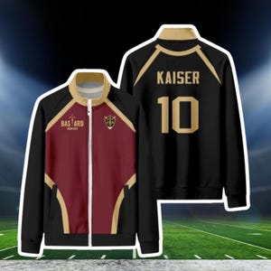 May include: Black, burgundy, and gold zip-up jacket. The front features the text "BAS ARD" and a crest. The back of the jacket displays "KAISER" and the number "10" in gold. The jacket has a stand-up collar.