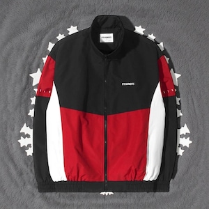 May include: A black, red, and white track jacket with a stand-up collar and a full-length zip. The jacket features colour-blocked panels and the text "STR GARMENTS" on the chest.