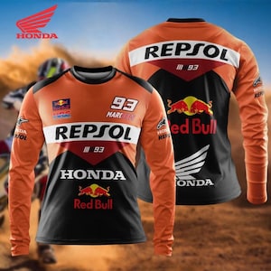 May include: Orange and black long-sleeve shirt featuring the Honda and Repsol logos, along with Red Bull branding. The number 93 is prominently displayed. The shirt has a color block design with white accents.