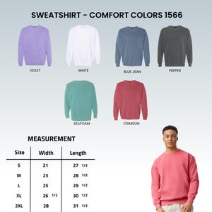 May include: A display of Comfort Colors 1566 sweatshirts in various colors, including violet, white, blue jean, pepper, seafoam, and crimson. The image also includes a size chart with measurements in inches for width and length.