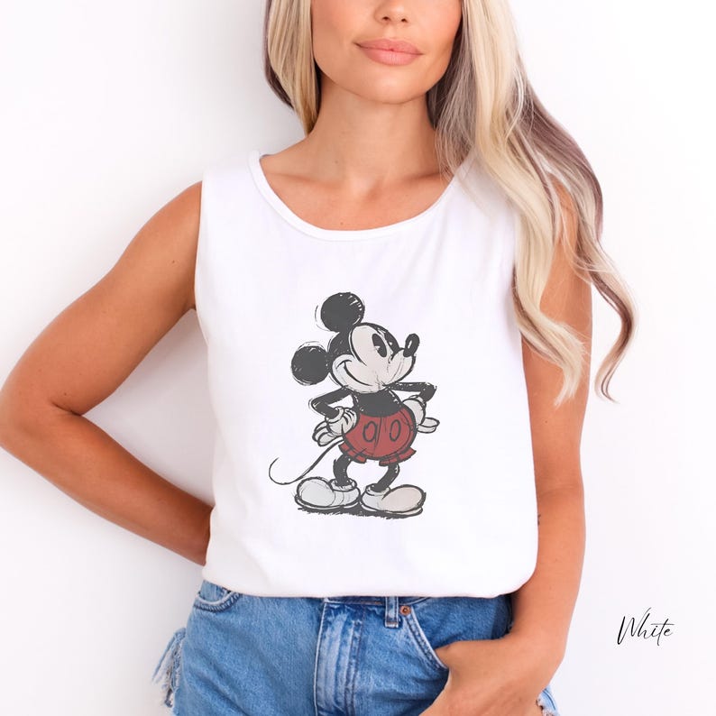 May include: A white sleeveless tank top featuring a distressed black and red graphic print of Mickey Mouse standing with hands on hips. The character design includes a black head and torso, red shorts, and white gloves and shoes in a vintage style.