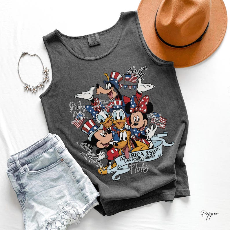 May include: A dark gray tank top featuring a graphic of Disney characters including Mickey Mouse, Minnie Mouse, Donald Duck, Daisy Duck, Goofy, and Pluto wearing patriotic hats. The text reads America 250th USA Anniversary 1776-2026.