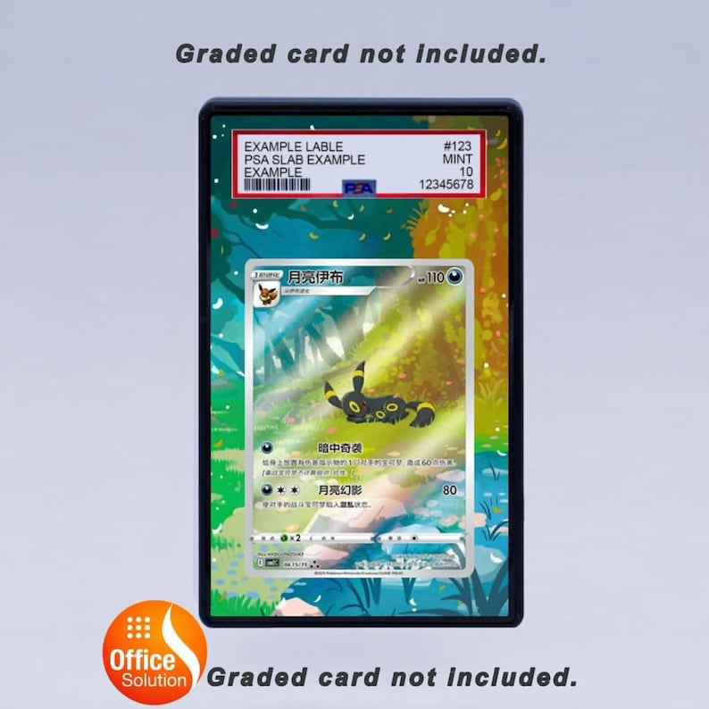May include: A graded card holder containing a Pok&eacute;mon card. The card shows a black and yellow Umbreon character with Japanese text. The holder has a PSA label with a barcode and the text "EXAMPLE LABLE". The text "Graded card not included" is also visible.