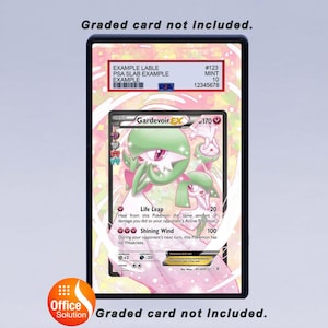 May include: A framed Pok&eacute;mon Gardevoir EX trading card. The card features a pink, green, and white illustration of the character. The frame includes a PSA label with a grade of 10 and the text "Graded card not included."