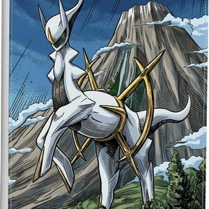 May include: A rectangular white binder featuring a graphic illustration of the white and gold creature Arceus standing in front of a large mountain and green forest. The creature has a circular gold ring around its midsection and green eyes.