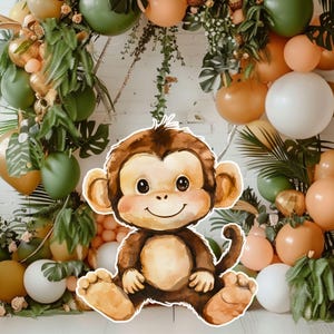 May include: A watercolor illustration of a smiling monkey with brown fur, sitting in front of a backdrop of balloons, greenery, and decorative elements in shades of green, orange, and white. The monkey has a friendly expression.