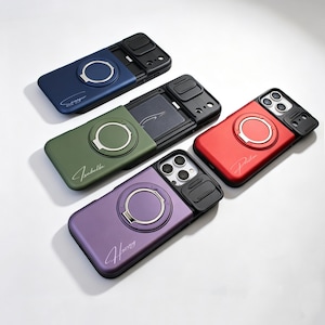 May include: Four smartphone cases in blue, olive green, red, and purple, each featuring a sliding black camera lens cover, a circular metallic ring stand on the back, and a personalised name written in white cursive script on the lower section.
