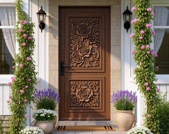 May include: A brown wooden front door featuring intricate carved rose floral patterns in two rectangular panels. The door is framed by white siding, climbing vines with pink flowers, and potted lavender and white daisy plants on stone steps.