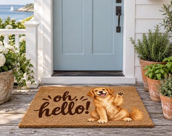 May include: A rectangular brown coir doormat featuring a golden retriever illustration with one paw raised and the text "oh, hello!" in dark brown script. The mat is positioned on a wooden porch in front of a light blue door.