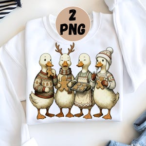 Puede incluir: Sudadera blanca con una ilustración caprichosa de cuatro patos vestidos con ropa de invierno. Los patos sostienen galletas de jengibre y llevan suéteres, bufandas y gorros. Un gráfico circular con el texto "2 PNG" está en la parte superior.