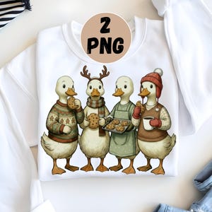 May include: White sweatshirt with a charming illustration of four ducks. The ducks are dressed in festive outfits, holding cookies, a tray of cookies, or a mug. The ducks wear a sweater, scarf, apron, and a hat. The image has a warm, inviting feel.