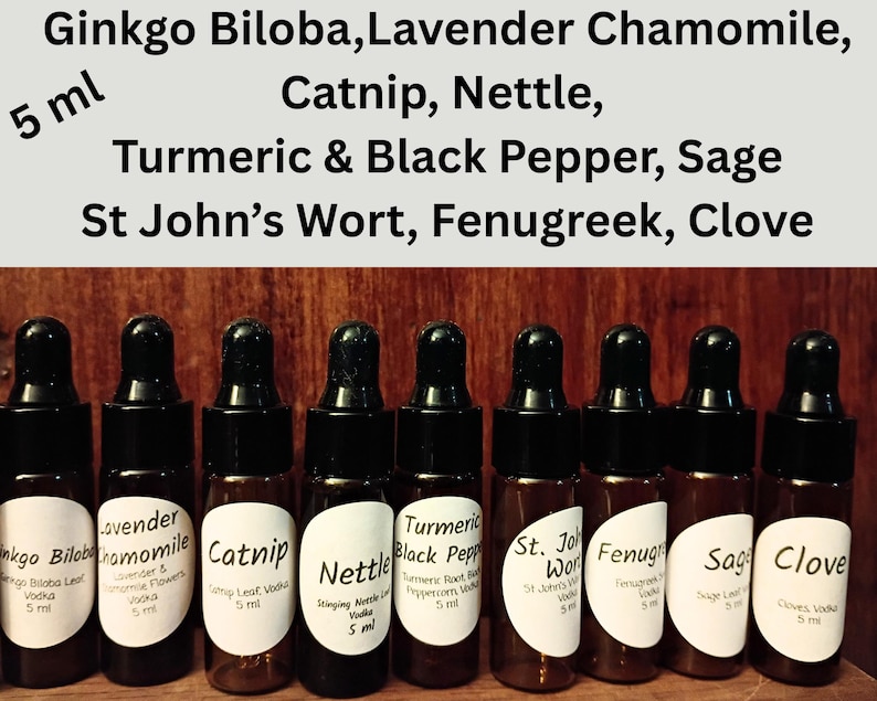 May include: A collection of eight small amber glass bottles with black droppers, each labeled with a different herbal extract name. The labels include "Ginkgo Biloba," "Lavender Chamomile," "Catnip," and more. The text "5 ml" is visible on the bottles.
