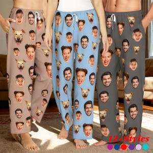 May include: Three pairs of pajama trousers in tan, light blue, and grey, each patterned with repeating faces and dog faces. The trousers have a drawstring waist. The text "12+ Styles" is visible at the bottom.