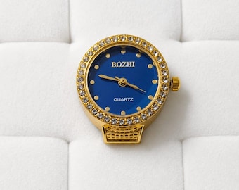 Anillo de reloj azul real dorado • Joyería con banda elástica y bisel de diamantes de imitación