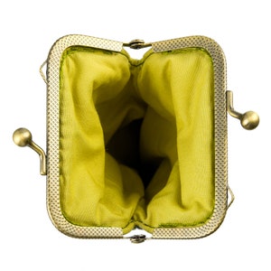 May include: A small, empty, green fabric coin purse with a gold metal frame and clasp.