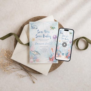 May include: A rectangular baby shower invitation card featuring watercolor illustrations of a whale, turtle, jellyfish, stingray, and crab with the text Sea You Soon Baby Lauren Smith. A smartphone displays the same digital invitation design.