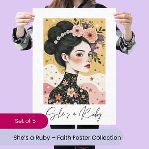May include: A poster featuring a woman with dark hair adorned with flowers and a floral patterned top. The poster has the text "She's a Ruby" and "She's a Ruby - Faith Poster Collection". The poster is held up by a person.
