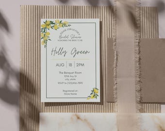May include: A bridal shower invitation with the text "Holly Green" and event details. The invitation features lemon branch illustrations and is set against a neutral background with a ribbon and paper elements.
