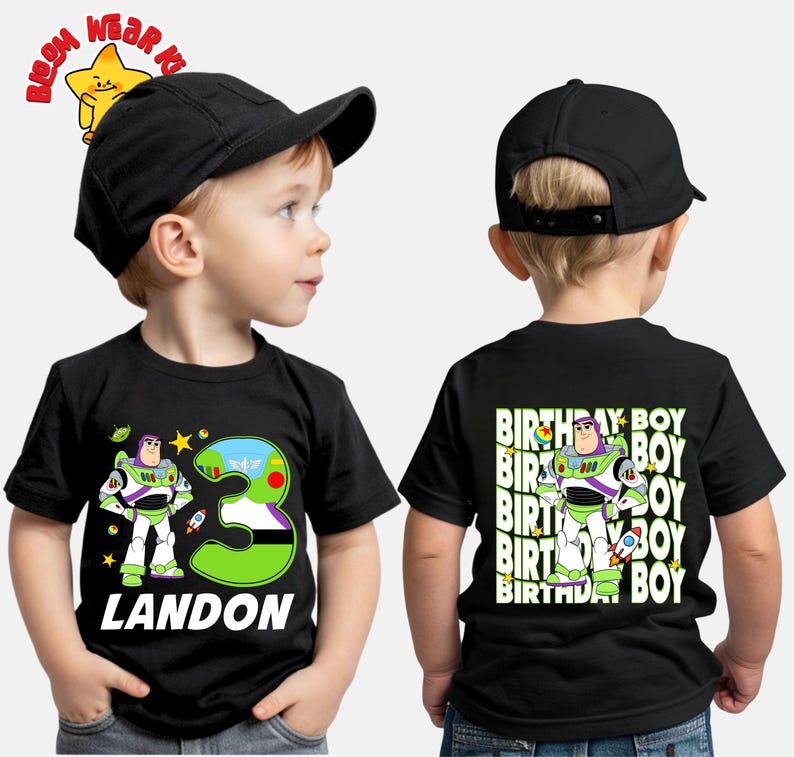 May include: Black t-shirt featuring a Buzz Lightyear graphic with the number 3 and the name "LANDON" in white. The back of the shirt has a Buzz Lightyear graphic and the words "BIRTHDAY BOY". The child is wearing a black baseball cap.