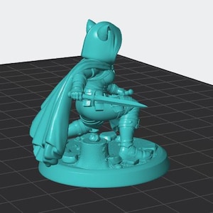 May include: A teal-coloured miniature figurine of a hooded character in a kneeling position. The figure wears a long cape, holds a sword in one hand, and is positioned on a circular base featuring a tree stump and scattered stones.