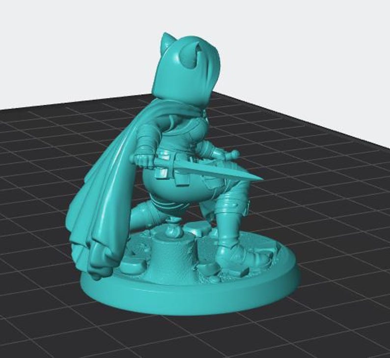 May include: A teal-coloured miniature figurine of a hooded character in a kneeling position. The figure wears a long cape, holds a sword in one hand, and is positioned on a circular base featuring a tree stump and scattered stones.