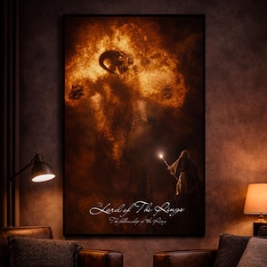 May include: A framed poster featuring a scene from "The Lord of the Rings: The Fellowship of the Ring." The artwork depicts a fiery, dramatic landscape with a figure holding a staff with a glowing light. The title is written in elegant script.