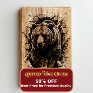May include: A rectangular wooden cutting board featuring a detailed illustration of a brown bear breaking through a wall. The bear is the focal point, with the wood grain adding texture. The board has a red label with text.