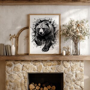 May include: Framed black and white artwork of a bear breaking through a wall. The bear is depicted with detailed fur and a determined expression. The artwork is displayed on a mantel above a stone fireplace, with decorative items.