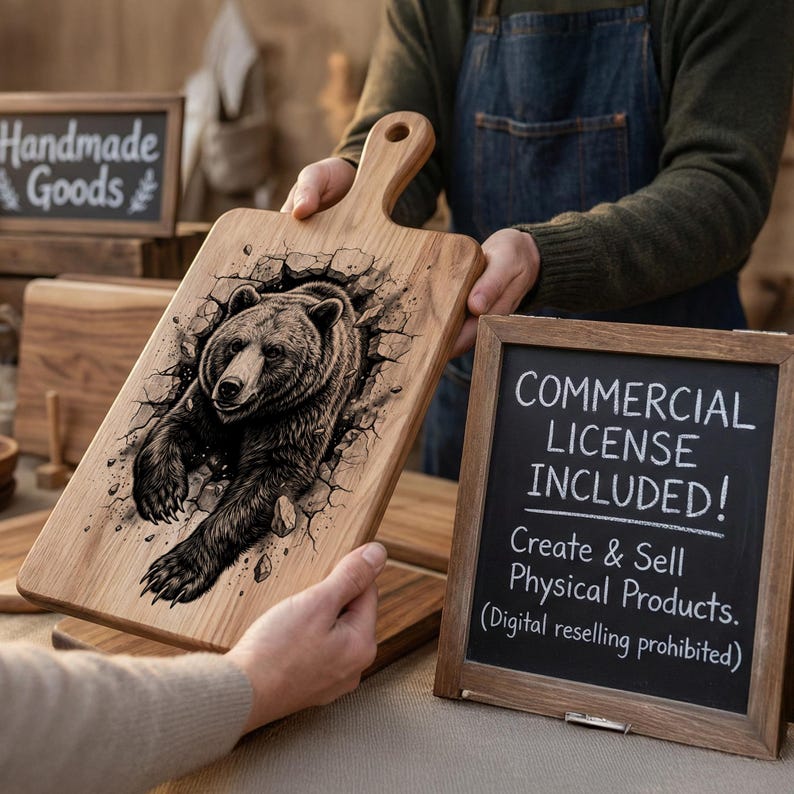 May include: Wooden cutting board with a handle, featuring a detailed illustration of a bear breaking through a wall. The board is light brown with a dark brown bear design. A small chalkboard sign reads "COMMERCIAL LICENSE INCLUDED!"