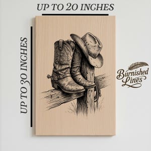 May include: A black and white illustration of cowboy boots and a hat resting on a wooden fence post. The artwork is on a light brown wooden panel. The text "Up to 20 inches" and "Up to 30 inches" is visible. The artwork is signed "Burnished Lines".