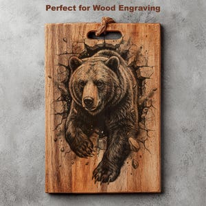 May include: Wooden cutting board with a detailed engraving of a grizzly bear breaking through a wall. The bear is brown and black, with a realistic depiction of fur and claws. The board has a handle and the text "Perfect for Wood Engraving".