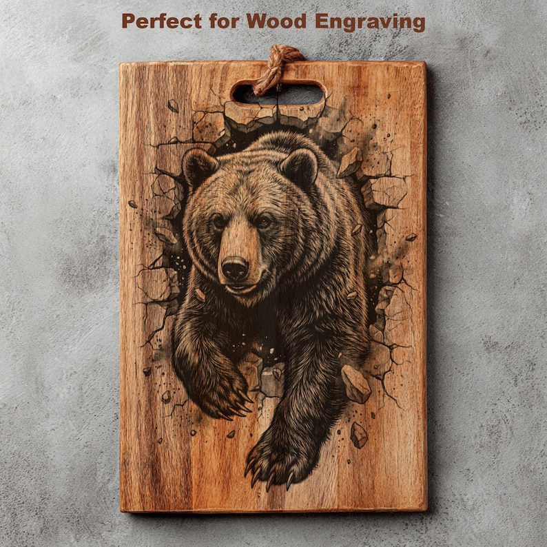 May include: Wooden cutting board with a detailed engraving of a grizzly bear breaking through a wall. The bear is brown and black, with a realistic depiction of fur and claws. The board has a handle and the text "Perfect for Wood Engraving".