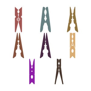 May include: A collection of eight decorative clothespins in various colors, including red, teal, brown, purple, and tan. Each pin has a unique design, with some featuring cut-out shapes and decorative elements. The clothespins are arranged on a white background.