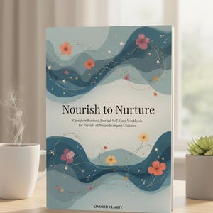 May include: A hardcover book titled "Nourish to Nurture" with a teal and white cover design. The cover features abstract wave patterns, floral accents, and the text "Caregiver Burnout Journal Self-Care Workbook for Parents of Neurodivergent Children."