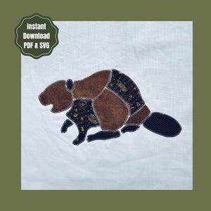 May include: A fabric applique of a beaver on a white background, constructed from brown and dark patterned fabric pieces with visible white zigzag stitching along the edges. The design includes the text Instant Download PDF & SVG.