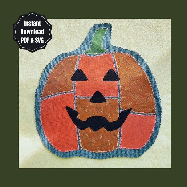 May include: A fabric pumpkin appliqu&eacute; with a jack-o'-lantern face featuring black triangular eyes, a triangular nose, and a wide, curved mouth. The pumpkin is constructed from orange and brown patterned fabric segments with a green stem.