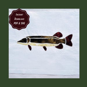 May include: A white fabric background featuring a fish applique with dark brown, tan, and deep red mottled fabric segments outlined in white stitching. A dark maroon badge in the upper left corner contains the text INSTANT DOWNLOAD PDF & SVG.