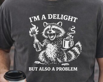 I'm a Delight But Also a Problem Shirt, Funny Raccoon Shirt, Chaos Goblin Tee, Coffee Lover Gift, Unhinged Humor Graphic Tee