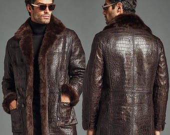 May include: A brown leather coat with a crocodile skin texture, featuring a fur collar and cuffs. The coat has a double-breasted design with two front pockets. The model is wearing sunglasses and a black turtleneck.
