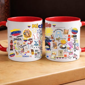 May include: White ceramic mug with a red interior and handle, decorated with colorful Venezuelan-themed illustrations and text. The design includes the Venezuelan flag, food items, and the name "Michelle".