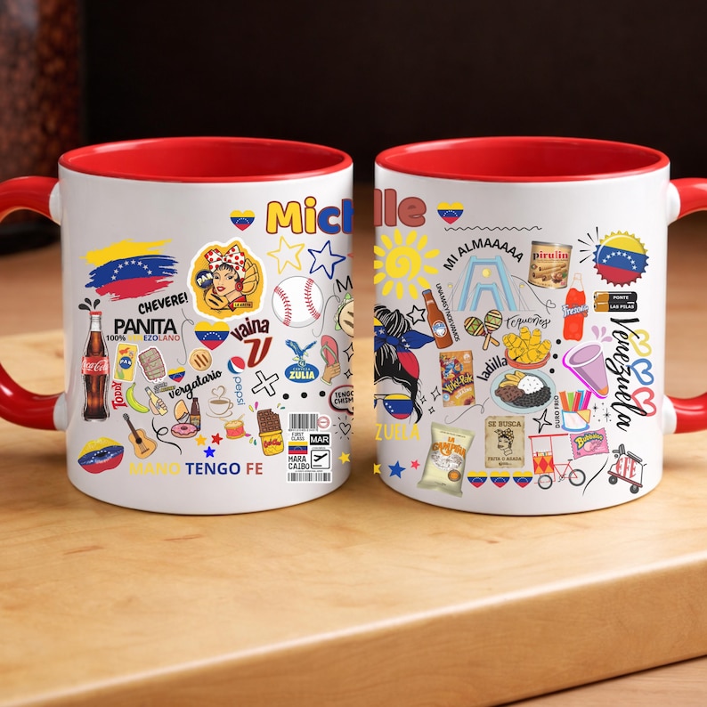 May include: White ceramic mug with a red interior and handle, decorated with colorful Venezuelan-themed illustrations and text. The design includes the Venezuelan flag, food items, and the name "Michelle".