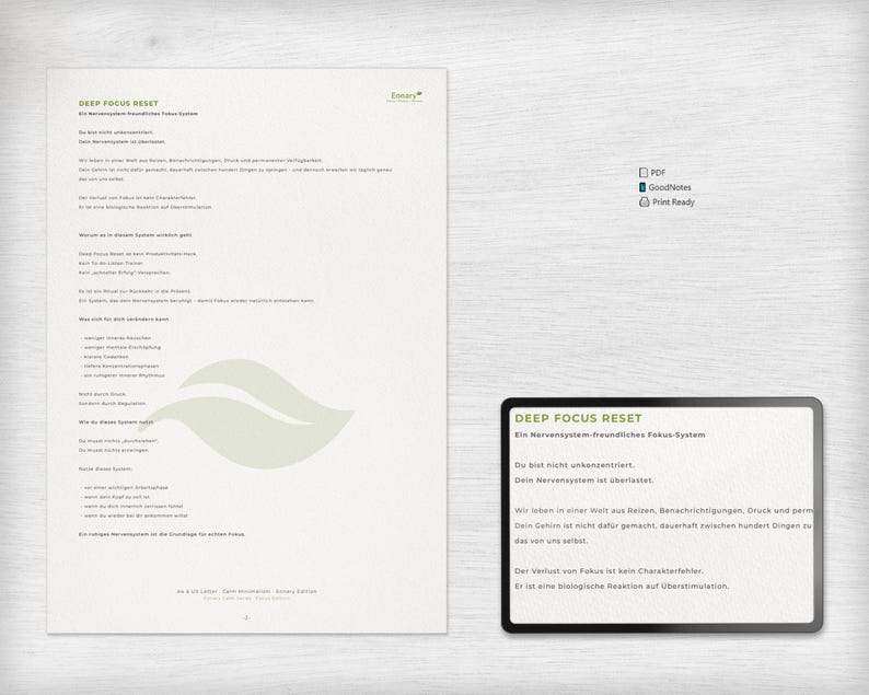 May include: A digital document with the title "DEEP FOCUS RESET" and text in German. The document is on a white background with a leaf design. A smaller digital card with the same title and text is also present.