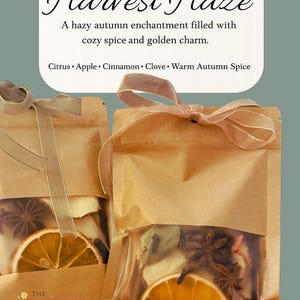 May include: Two brown paper pouches tied with sheer ribbons, filled with dried citrus slices, star anise, and other spices. The text "Harvest Haze" is at the top, with "Citrus, Apple, Cinnamon, Clove, Warm Autumn Spice" below.