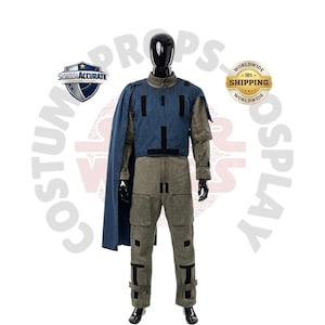 May include: A full-body costume on a black mannequin. The costume includes a blue vest with black accents, a long-sleeved olive green shirt, and matching pants. A blue cape is draped over the left shoulder. The costume is labeled "Screen Accurate" and "Worldwide Shipping".