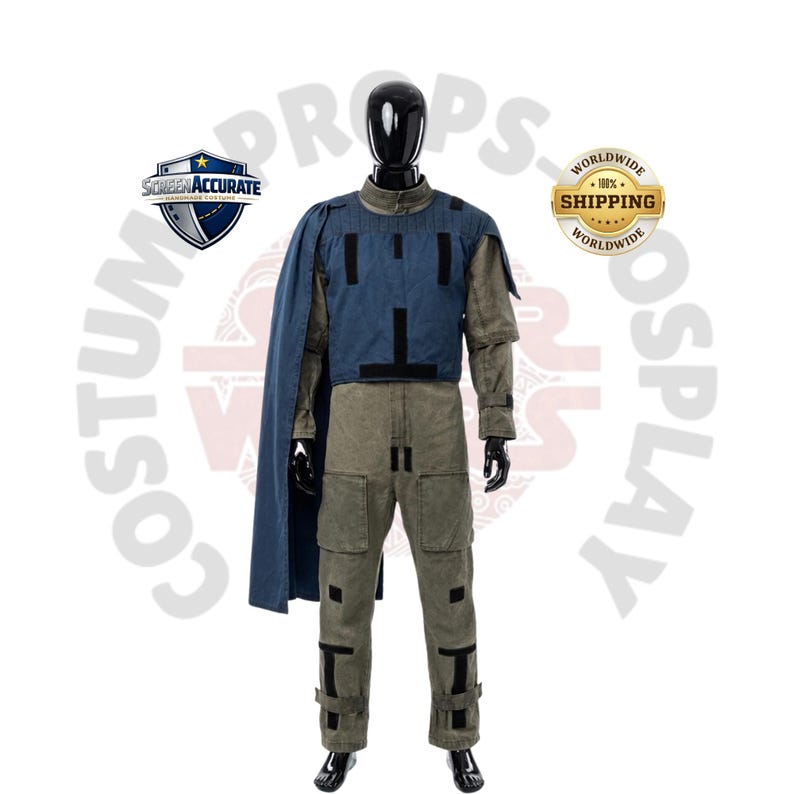 May include: A full-body costume on a black mannequin. The costume includes a blue vest with black accents, a long-sleeved olive green shirt, and matching pants. A blue cape is draped over the left shoulder. The costume is labeled "Screen Accurate" and "Worldwide Shipping".